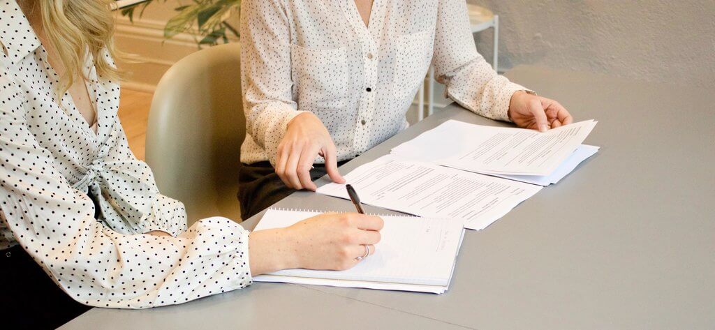 Person preparing documents at a desk, representing Amazon's memo-writing practice