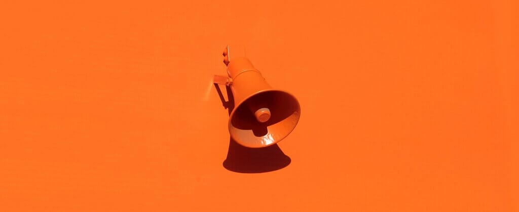 Orange megaphone representing a meeting facilitator's role in guiding discussion