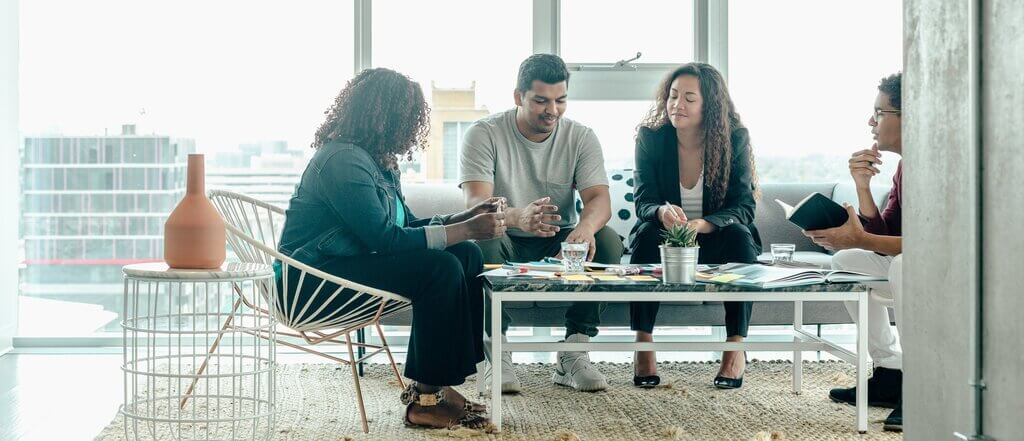 Team gathered around a table in a modern office meeting room