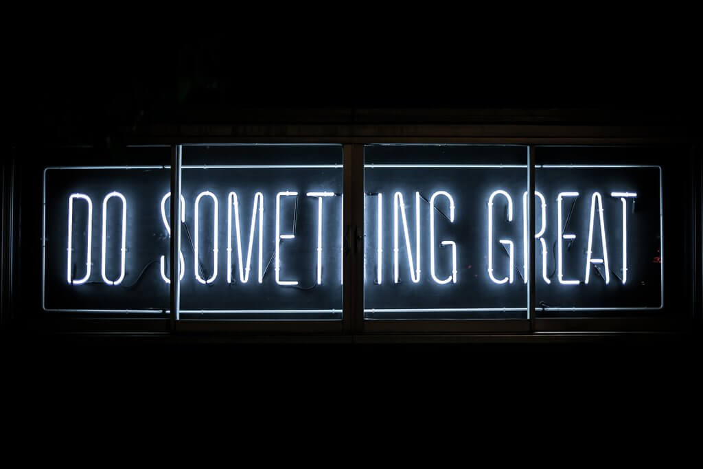 Neon sign reading "Do Something Great" representing a culture of high standards